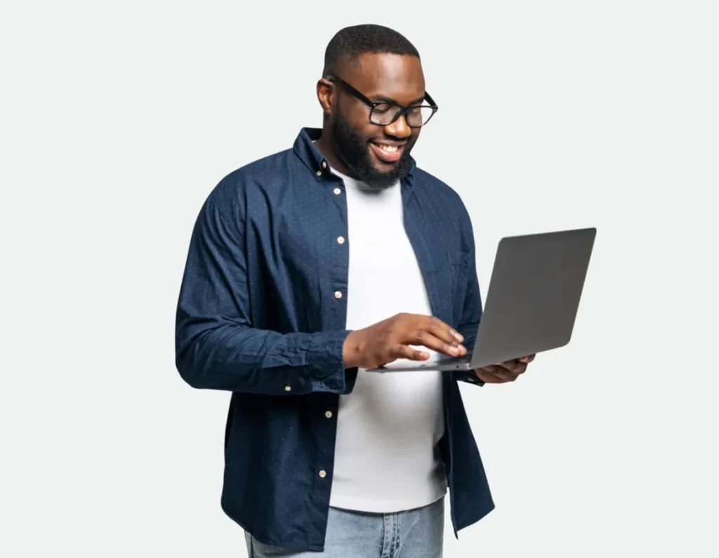 A man with glasses and a beard works on a laptop, representing collaboration in LA small business partnerships.